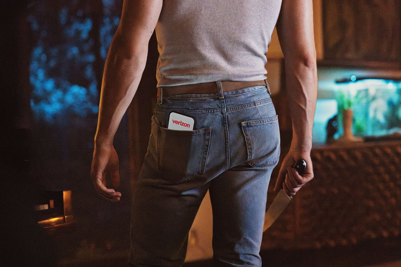 Connor Storrie with a cell phone showing the Verizon logo in his back pocket.
