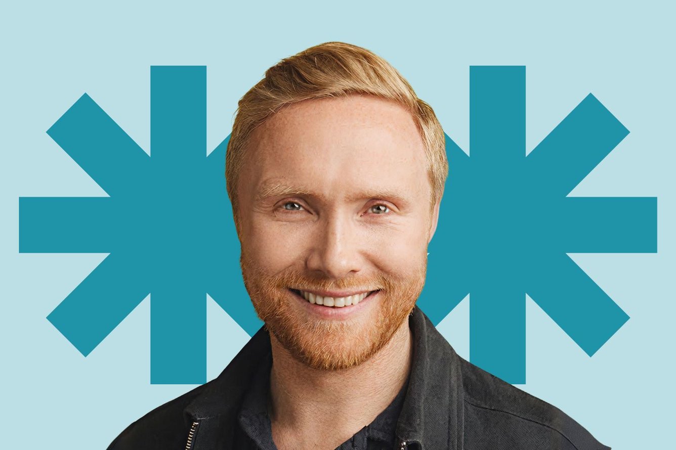 Headshot of Fintan Gillespie, a man with short strawberry blonde hair and a beard, smiling at the camera.